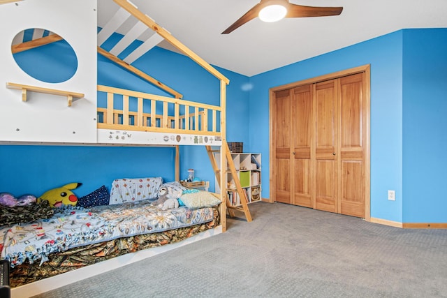 carpeted bedroom with ceiling fan and a closet