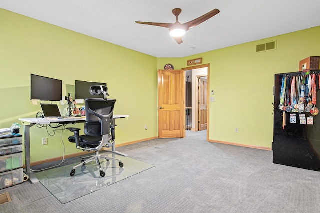 carpeted office with ceiling fan