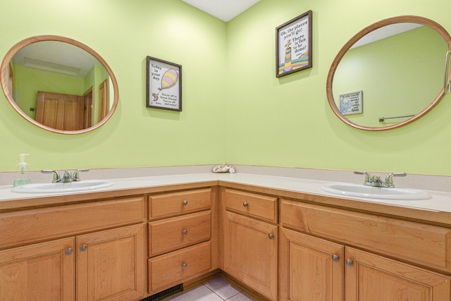 bathroom with tile patterned flooring and vanity