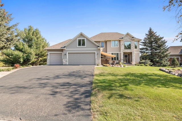 view of front of home featuring a front yard and a garage