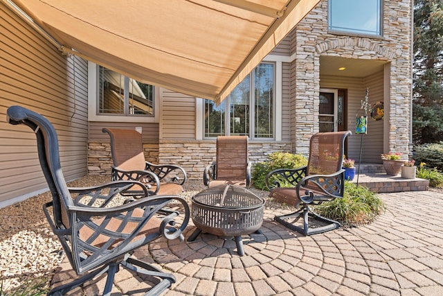 view of patio / terrace with an outdoor fire pit