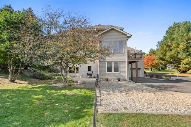 rear view of property featuring a yard and a garage