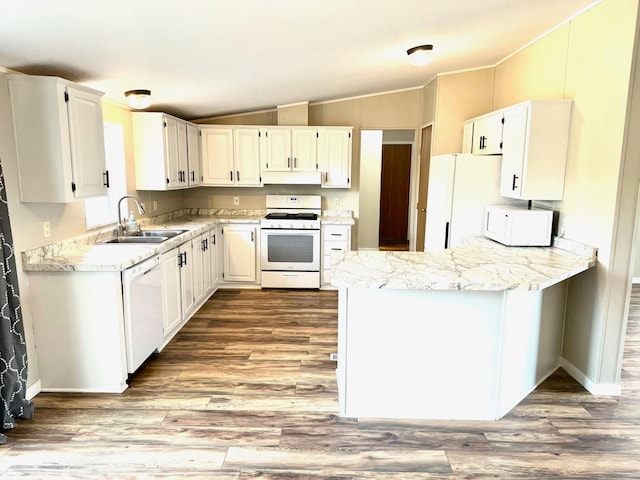 kitchen with sink, vaulted ceiling, white cabinetry, and white appliances