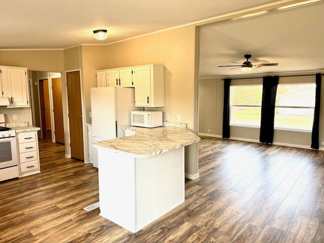 kitchen with lofted ceiling, kitchen peninsula, white cabinets, white appliances, and dark hardwood / wood-style flooring