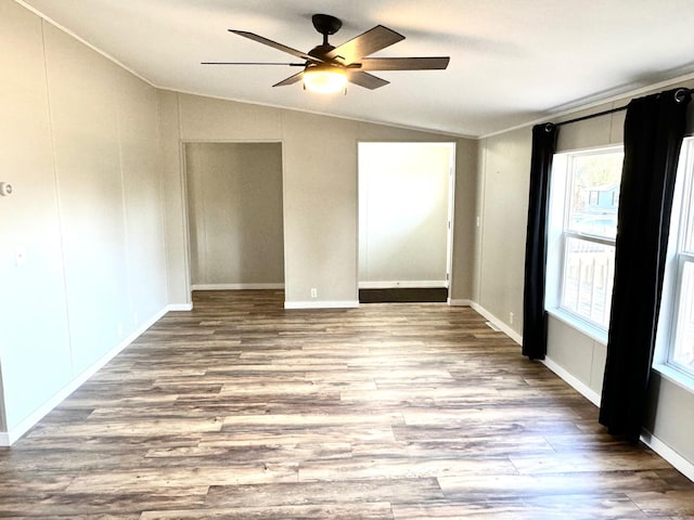 spare room featuring vaulted ceiling, light hardwood / wood-style flooring, and ceiling fan