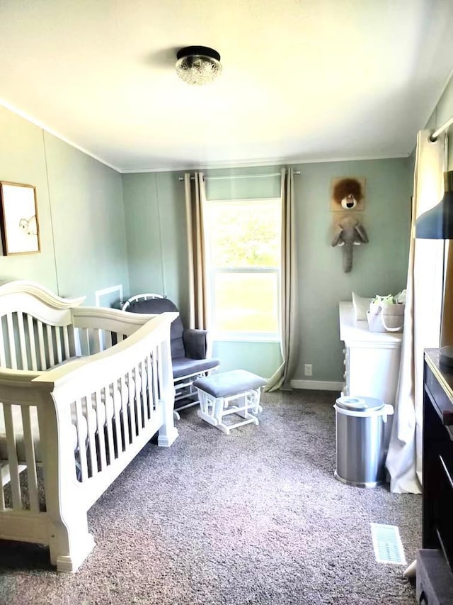 carpeted bedroom featuring a crib