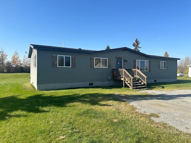 rear view of property featuring a lawn