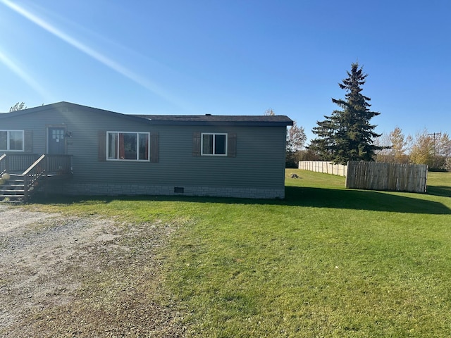 rear view of property featuring a yard