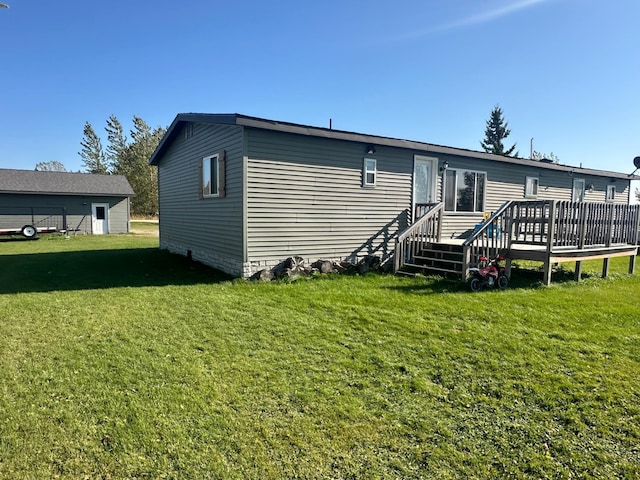 back of property with a deck and a lawn