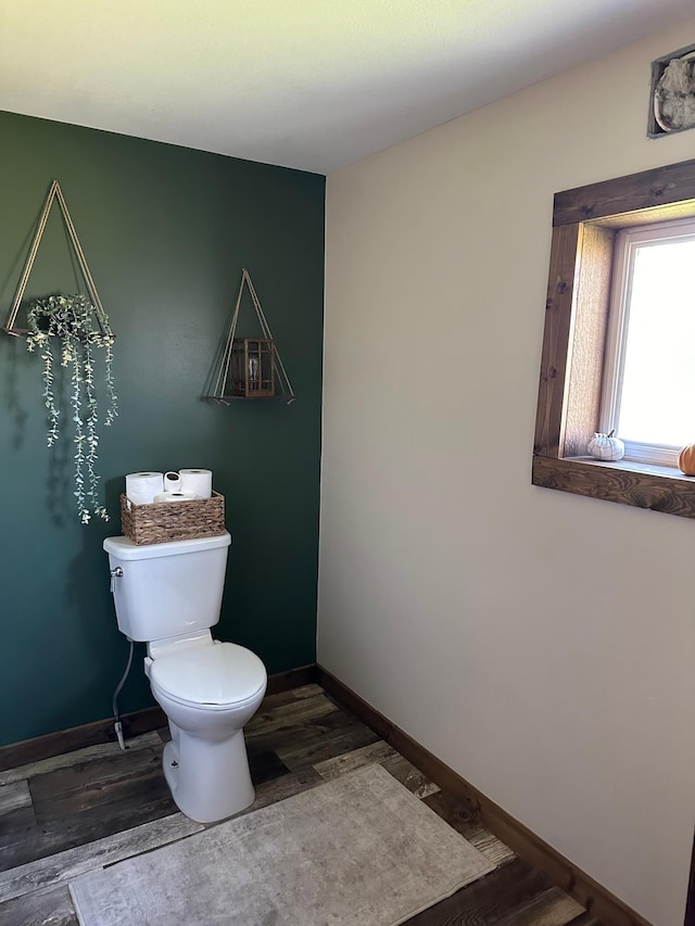 bathroom featuring toilet and wood-type flooring