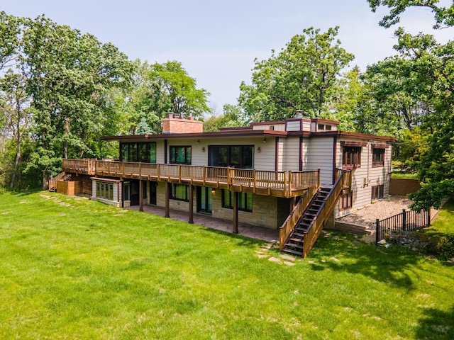 1425 20th St SW, Rochester, MN 55902 - rear view of house with stairway, a wooden deck, a chimney, and a lawn