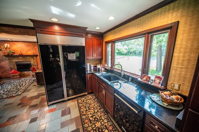 1425 20th St SW, Rochester, MN 55902 - kitchen with built in refrigerator, crown molding, dishwasher, a stone fireplace, and dark countertops