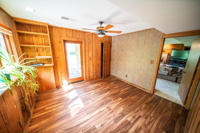 1425 20th St SW, Rochester, MN 55902 - spare room featuring ceiling fan, wood finished floors, and wooden walls