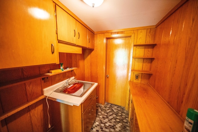 1425 20th St SW, Rochester, MN 55902 - kitchen featuring wooden walls, open shelves, light countertops, brown cabinets, and dark tile patterned floors
