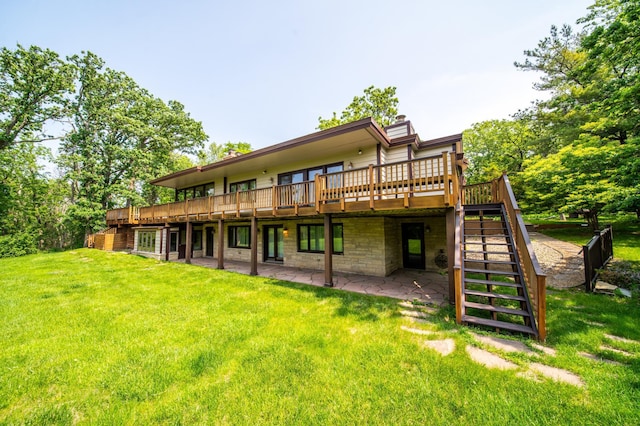 1425 20th St SW, Rochester, MN 55902 - back of property featuring a lawn, a wooden deck, stairway, a patio, and a chimney