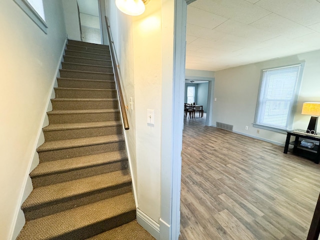 stairs with wood-type flooring