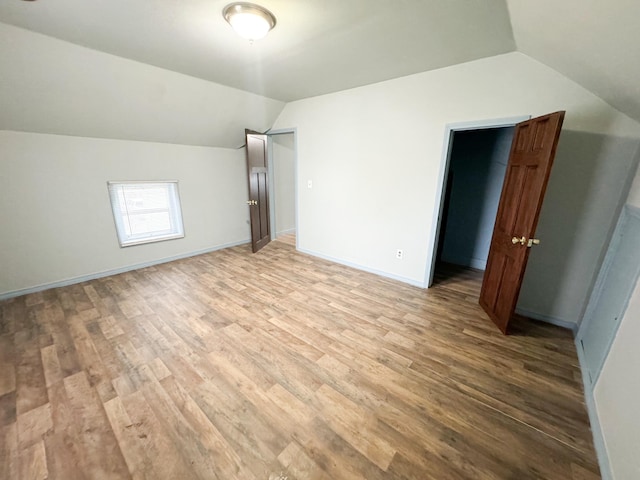 bonus room featuring light hardwood / wood-style flooring and vaulted ceiling