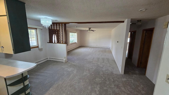 unfurnished living room with dark carpet, a baseboard radiator, a textured ceiling, and ceiling fan with notable chandelier