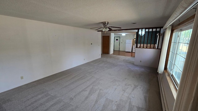 carpeted spare room with ceiling fan and a textured ceiling