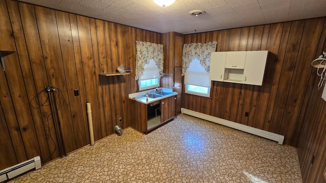 interior space with wooden walls and a baseboard radiator