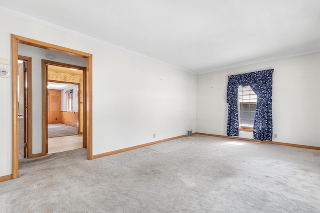 carpeted spare room featuring ornamental molding