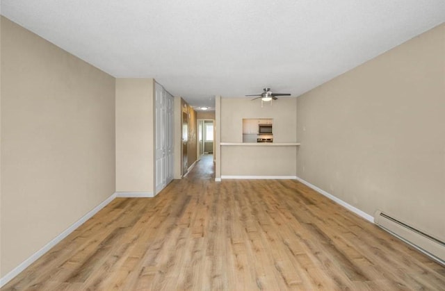 unfurnished living room featuring ceiling fan, a baseboard heating unit, and light wood-type flooring