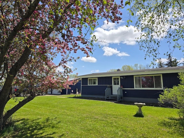 single story home with entry steps and a front lawn