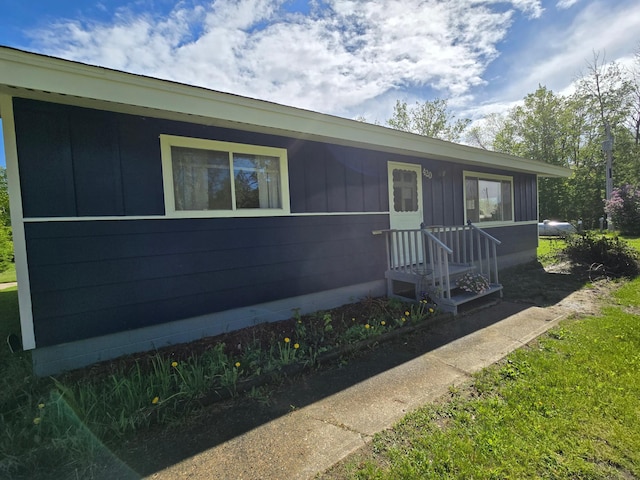 ranch-style house featuring board and batten siding