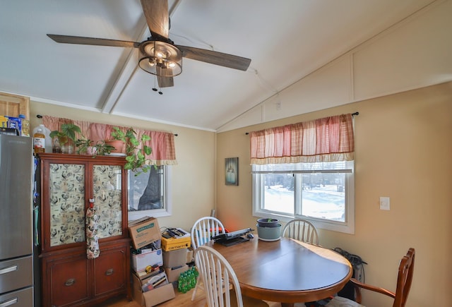 dining space featuring lofted ceiling and a ceiling fan