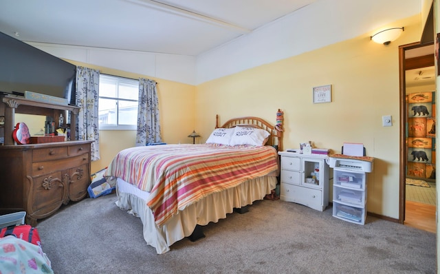 bedroom with lofted ceiling and carpet flooring