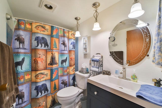 bathroom with lofted ceiling, a shower with shower curtain, vanity, and toilet