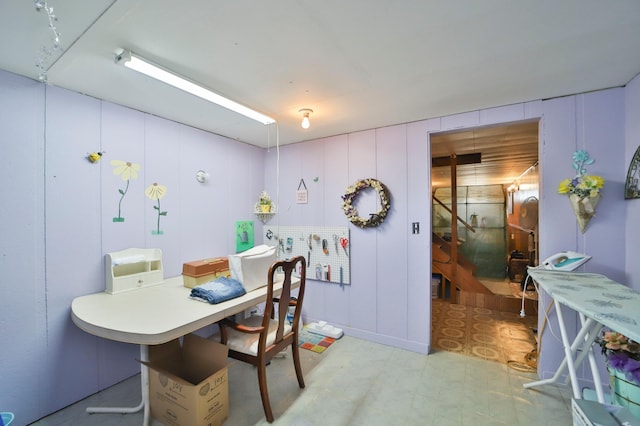 dining room with light floors and a decorative wall