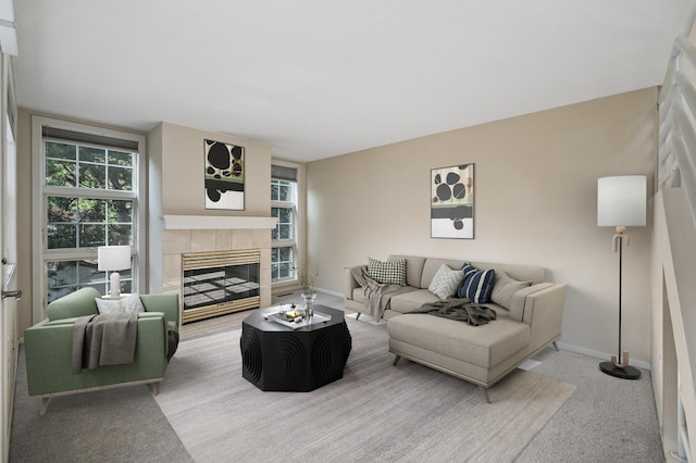 carpeted living room featuring a healthy amount of sunlight and a fireplace