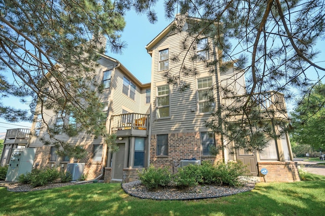 rear view of property with a lawn