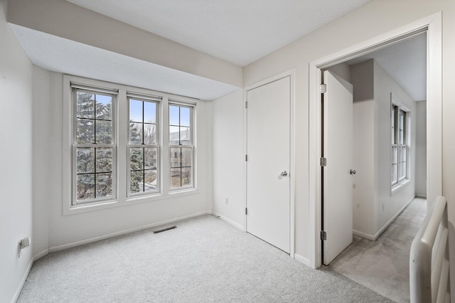 unfurnished bedroom with light carpet