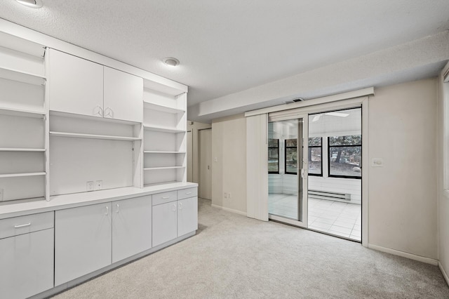 interior space with light colored carpet and a textured ceiling