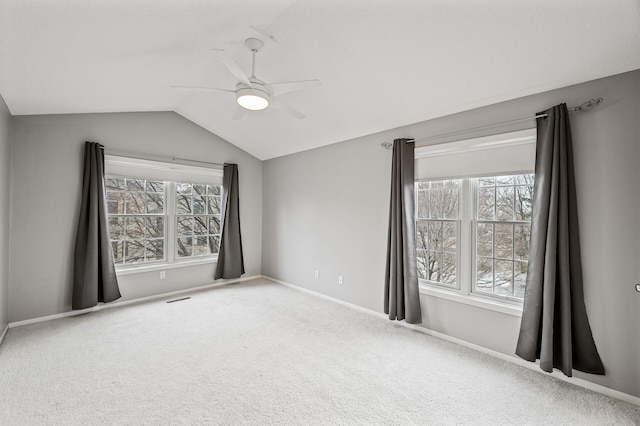 carpeted empty room with lofted ceiling and ceiling fan