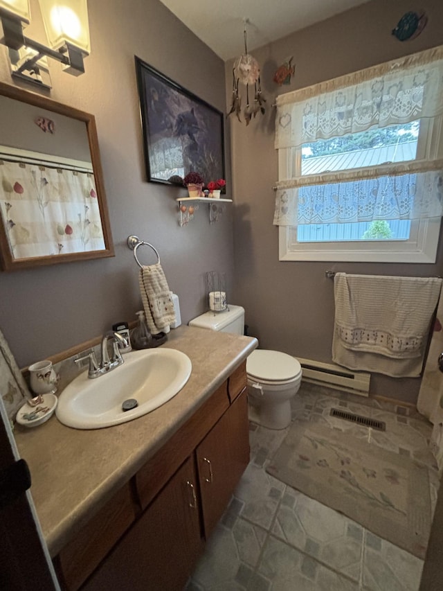 bathroom with baseboard heating, vanity, and toilet