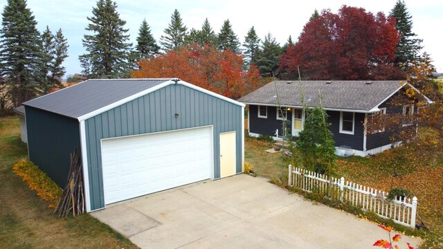 single story home featuring an outbuilding and a garage