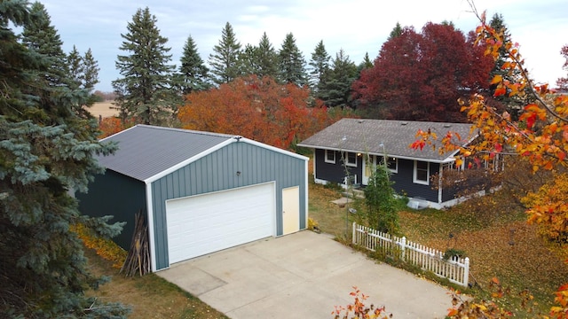 detached garage featuring fence