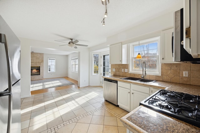 kitchen featuring stainless steel appliances, tasteful backsplash, sink, and white cabinets