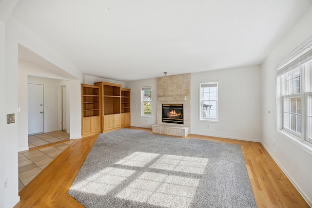 unfurnished living room featuring a fireplace and light wood-type flooring