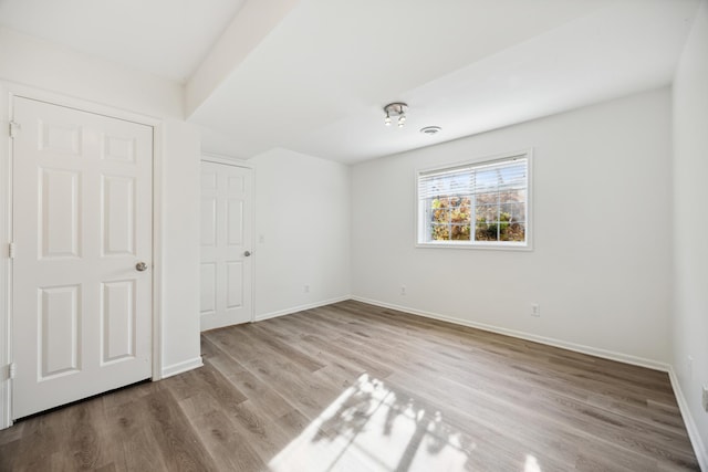 unfurnished bedroom featuring a closet and light hardwood / wood-style flooring