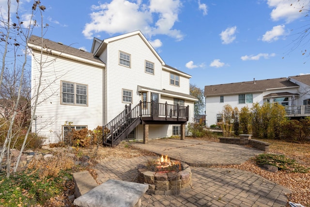 rear view of property with a patio, an outdoor fire pit, and a wooden deck