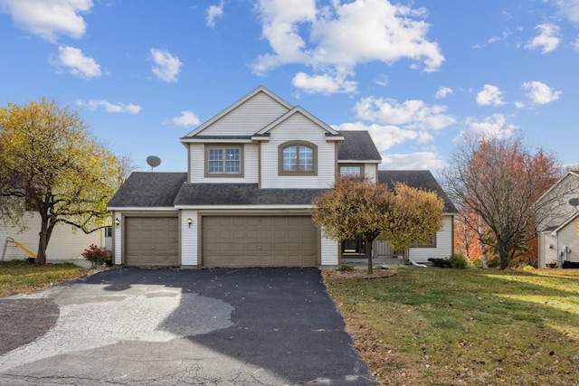 view of property with a front lawn and a garage