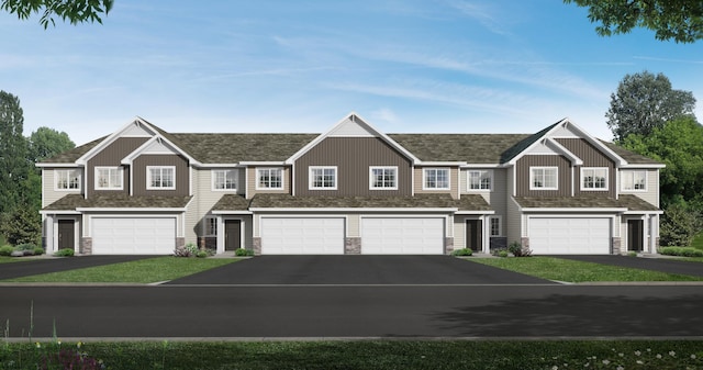 view of property featuring a garage and a front lawn