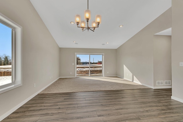 1710 Maple Leaf Ln, Litchfield, MN 55355 - spare room featuring a chandelier, baseboards, visible vents, and wood finished floors