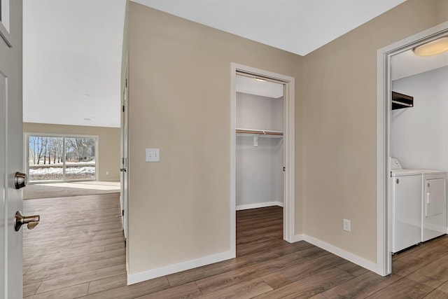 1710 Maple Leaf Ln, Litchfield, MN 55355 - unfurnished bedroom with baseboards, a walk in closet, independent washer and dryer, and wood finished floors