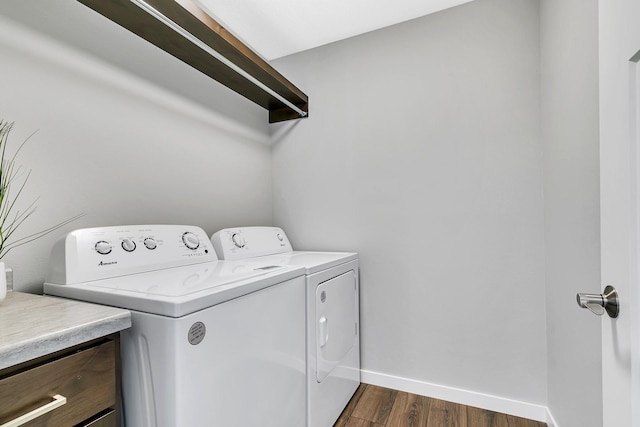 laundry room with washing machine and dryer and dark hardwood / wood-style floors