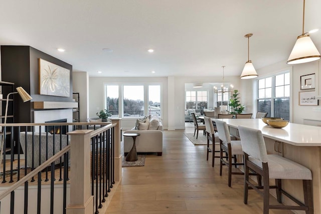 living room featuring a notable chandelier and light hardwood / wood-style flooring